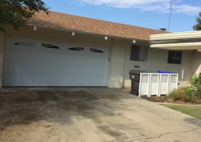 A technician installs a new garage door on a residential home