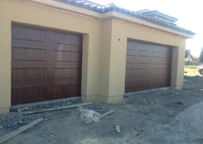 A garage door is being installed on a house